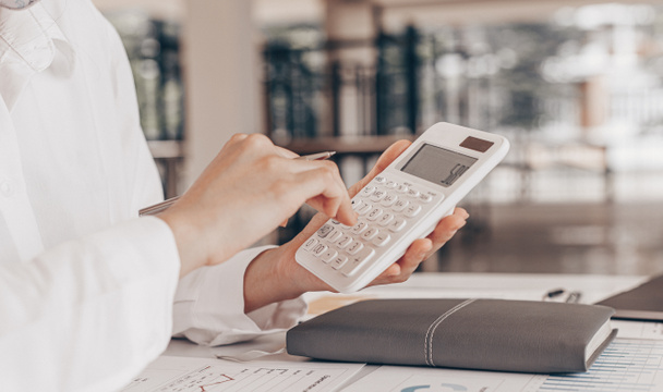 Accounting businessmen are calculating income-expenditure and analyzing real estate investment data, Financial and tax systems concept. - Photo, Image