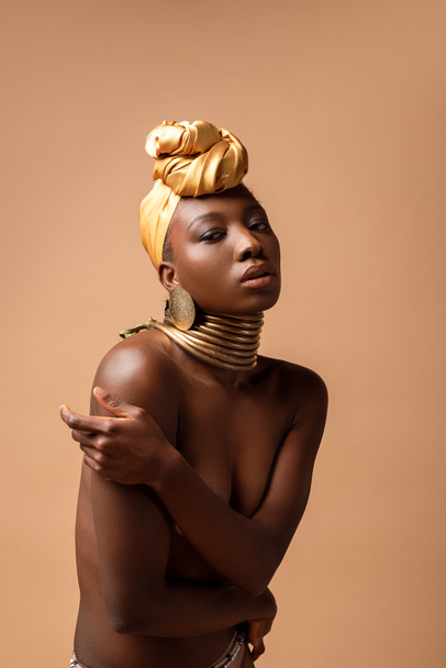 sexy naked tribal afro woman posing isolated on beige - Photo, Image