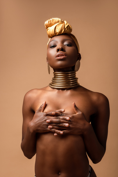 sexy naked tribal afro woman posing isolated on beige - Photo, Image