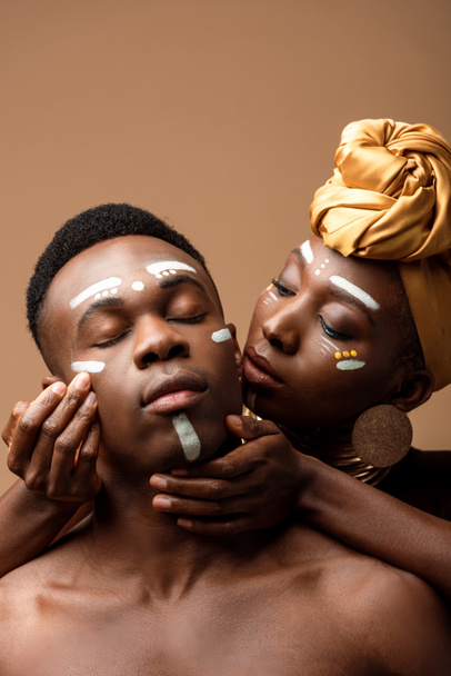 naked tribal afro couple with painted faces isolated on beige - Photo, Image