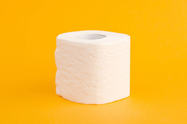 Toilet paper roll on a yellow background - Photo, Image