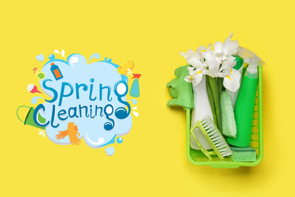 Set of cleaning supplies and spring flowers on color background - Photo, Image