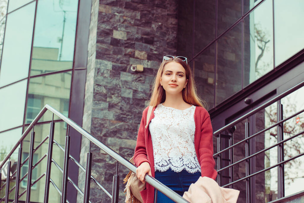 Business Woman girl student descends on stairs, well disposed outside business office building school university, positive face expression - Zdjęcie, obraz