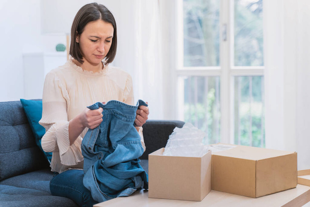 Woman feeling dissatisfied with received order at home - Photo, Image