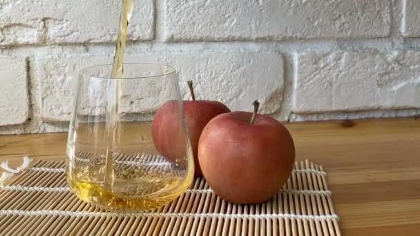 Νόστιμο φρέσκο χυμό μήλου σε διαφανές γυαλί - Πλάνα, βίντεο