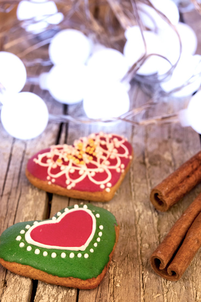 Gingerbread cookies and Christmas decoration over wooden table - Foto, imagen
