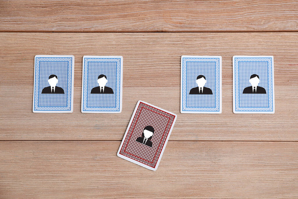 Cards with drawn human figures on wooden table. Concept of dismissal - Photo, Image