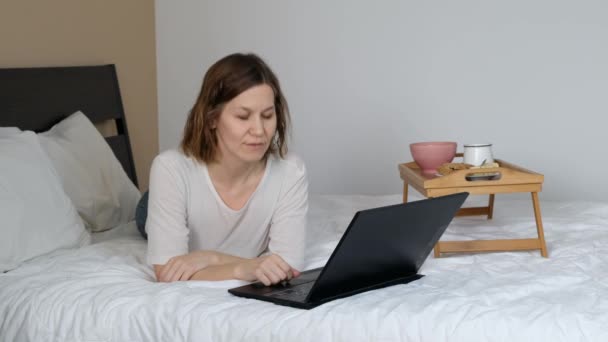 Woman working at home with laptop, voice call while quarantine of coronavirus - Кадри, відео