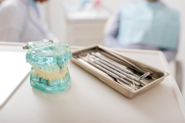 selective focus of dental instruments near teeth model in clinic  - Zdjęcie, obraz