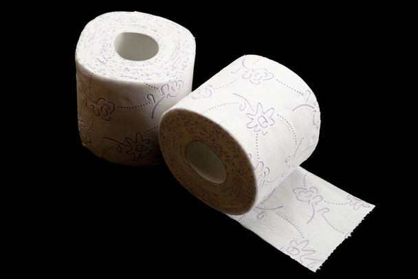 Tissue roll isolated on black. Toilet paper bathroom background. Cleaning concept product photograph for advertising - Photo, Image
