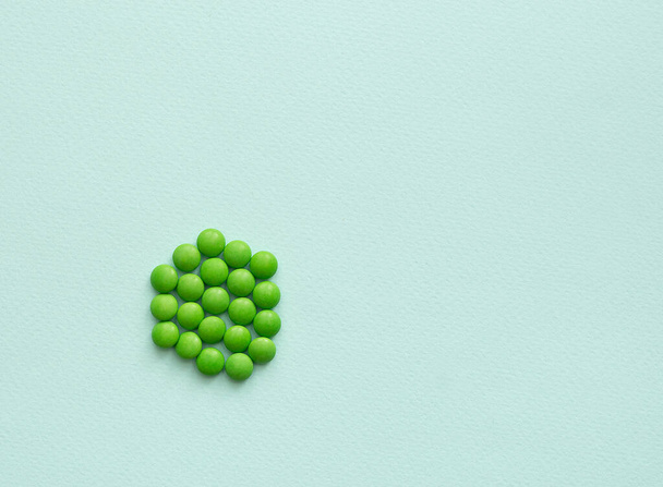 green pills on a blue background from the disease. medicine - Fotó, kép