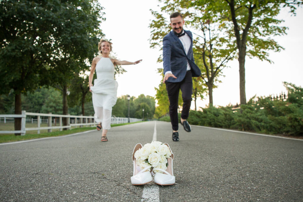 Newlyweds run to distill for a bouquet of brides - Фото, изображение