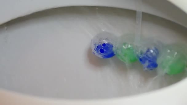 Refreshing cleanser means for cleaning of toilet bowls. Toilet bowl flushing water in bathroom close up. - Footage, Video