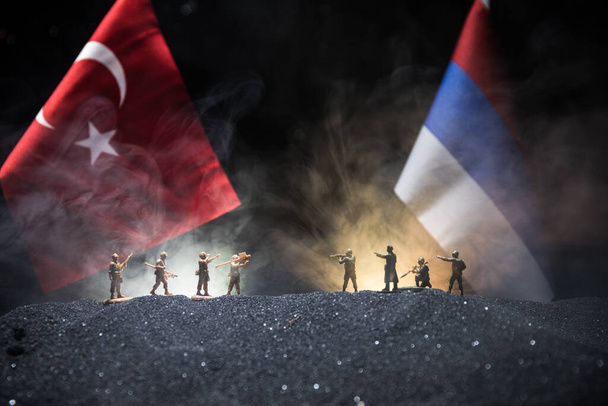 Russia and Turkey small flag on dark background. Concept of crisis of war and political conflicts between nations. Selective focus - Photo, Image