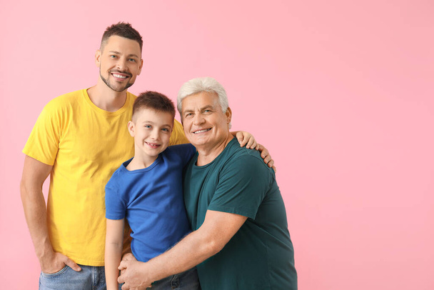 Man with his father and son on color background - Foto, Imagem