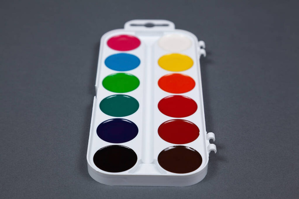 Set of watercolor paints on a gray background - Foto, Bild