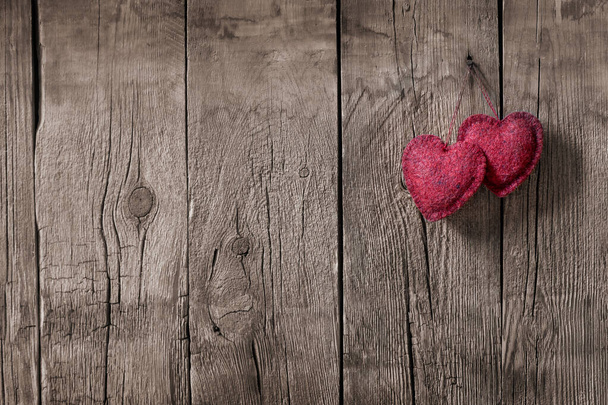 two red hearts on a background of an old wooden wall, concept of love, background for Valentine's day - Foto, Bild
