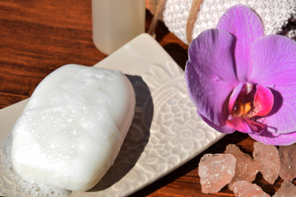 white soap with foam among purple flowers - Foto, immagini