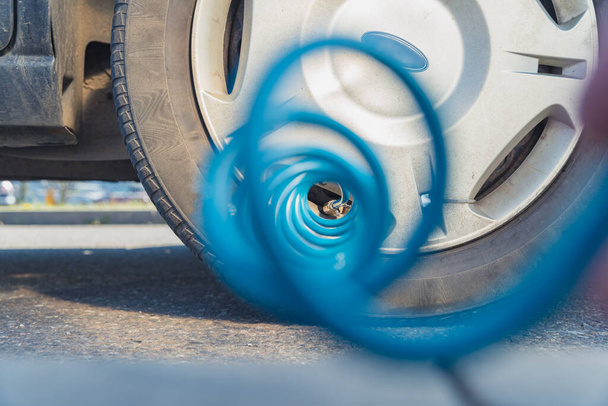 inflating the car tires with air using a compressor - Photo, Image