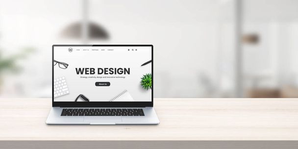 Web design studio promo webové stránky na displeji notebooku na kancelářském stole koncept - Fotografie, Obrázek