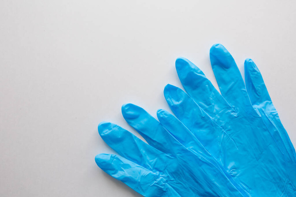Blue medical gloves on a white background. Copy space. covid-19 protection. Coronavirus Epidemic . - Photo, image