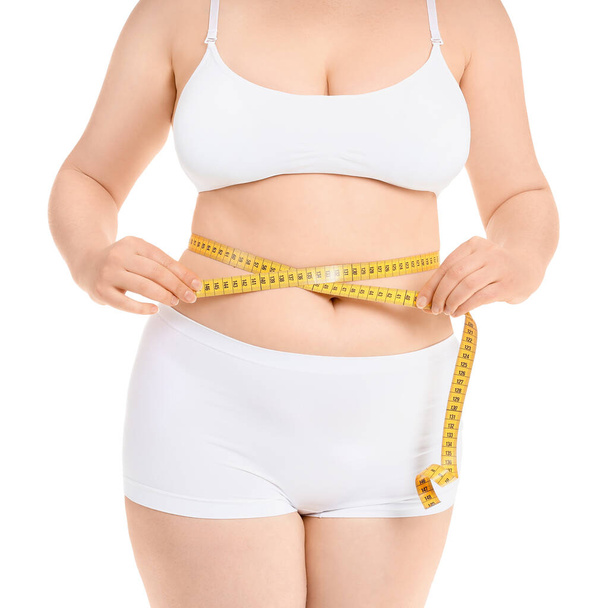 Overweight woman with measuring tape on white background. Weight loss concept - Foto, Bild