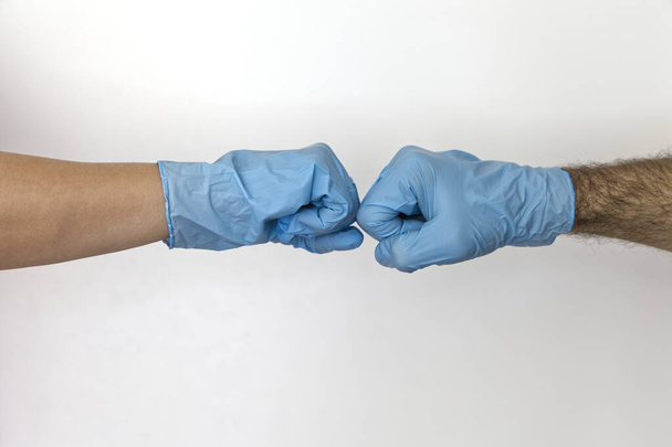 corona fists in latex gloves isolated on white against coronavirus  - Photo, Image