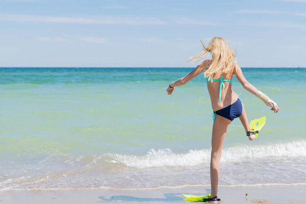 A teenage girl in fins by the sea, ocean. - Foto, Imagem
