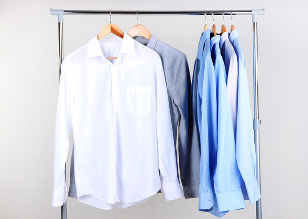 Office male clothes on hangers, on gray background - 写真・画像