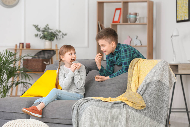 Cute little children eating chocolate at home - Foto, afbeelding