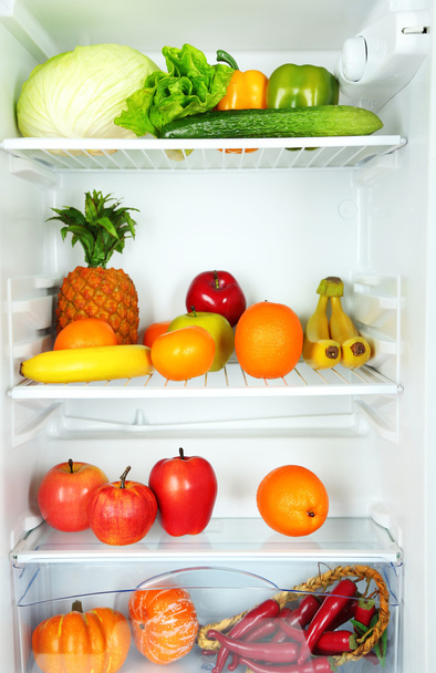 Vegetables and fruits in open refrigerator. Weight loss diet concept. - Fotó, kép