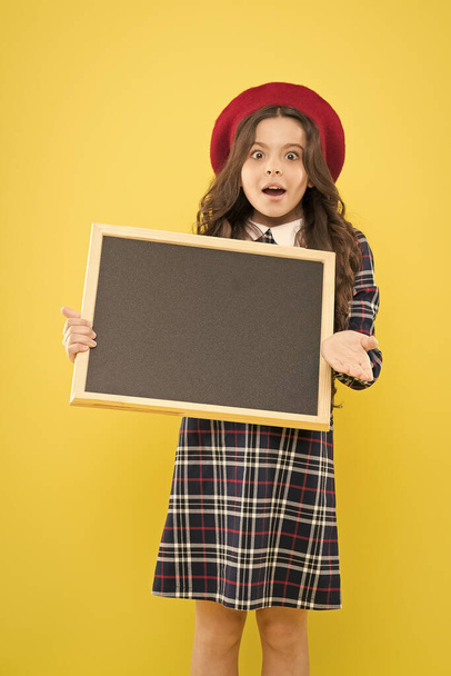 Girl hold blank blackboard. Advertising product copy space. Back to school concept. School information. Informing you. Expect the unexpected. Child promo information board. Place for information - Фото, зображення