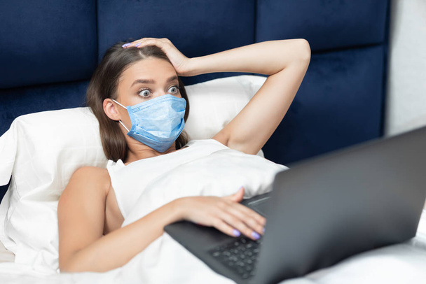 Shocked Woman Using Laptop Wearing Protective Mask At Home - Photo, Image