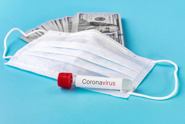 Medical mask and background of the us banknote. The epidemic of coronavirus. - Fotoğraf, Görsel