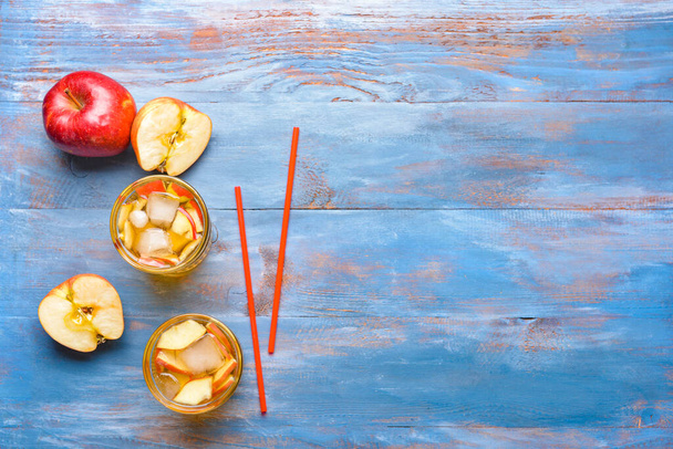 Glasses of tasty cold ice tea on color wooden background - Photo, Image