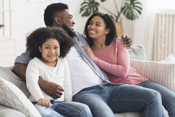 Cute Little African American Girl Relaxing At Home With Her Parents - Photo, Image