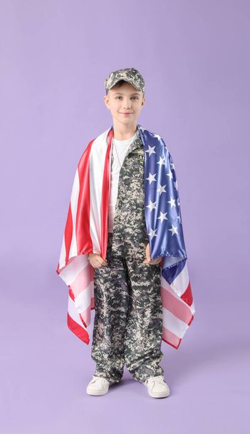 Cute little soldier with USA flag on color background - Photo, Image