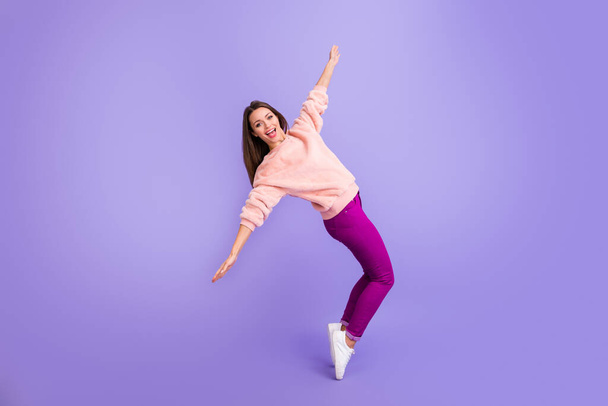 Full length profile photo of funny lady rejoicing spend lovely free time dancing youth party wear casual fur fuzzy sweater pants sneakers isolated purple color background - Zdjęcie, obraz