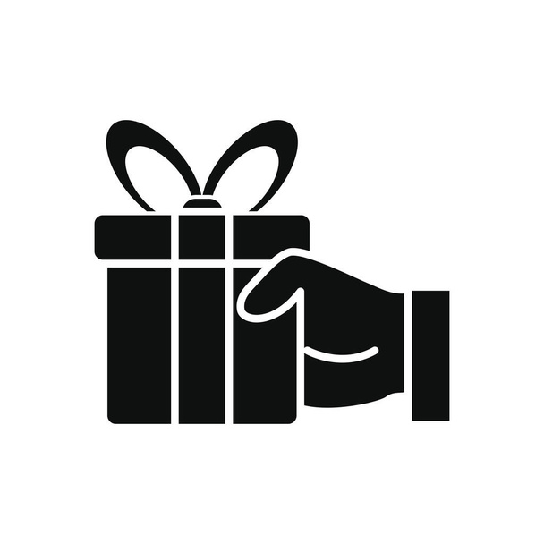 main tenant une icône boîte cadeau, style silhouette
 - Vecteur, image