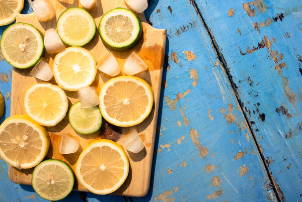 Lemon slices on a wooden background. Top view. Free space for text. - Zdjęcie, obraz