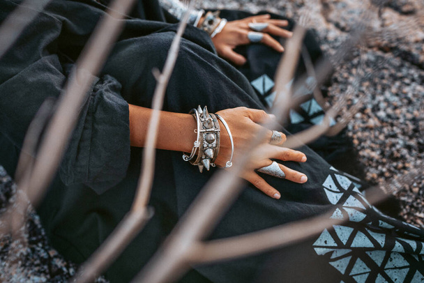 close up of tribal style woman hands with oriental accessories outdoors - Φωτογραφία, εικόνα
