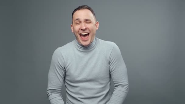 Video of laughing man in turtleneck - Video