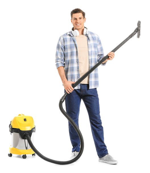Young man with vacuum cleaner on white background - Фото, зображення