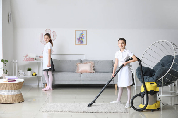 Cute little chambermaids cleaning room - Photo, Image