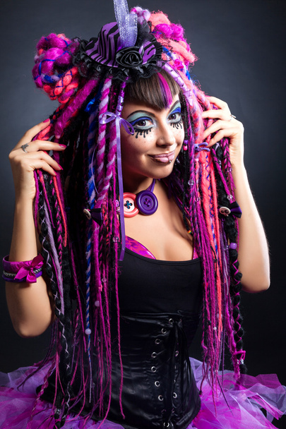 Portrait of a woman with multicolored dreadlocks and stylish mak - Foto, afbeelding