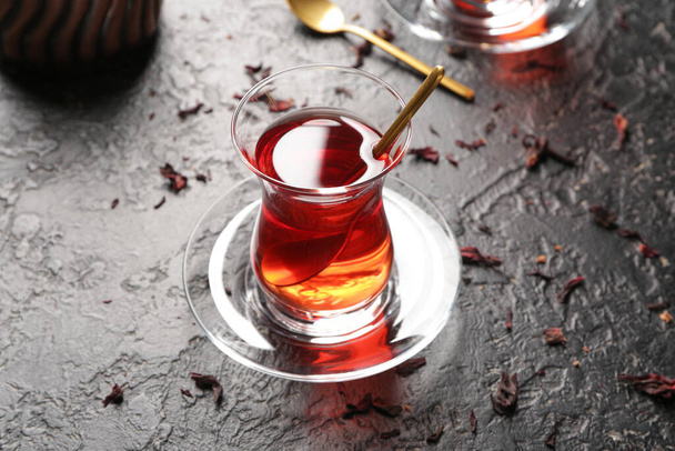 Glass of tasty Turkish tea on dark background - Fotó, kép