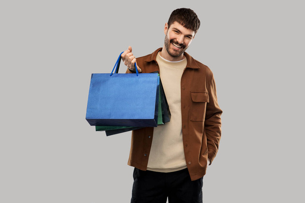 happy smiling young man with shopping bags - Photo, Image