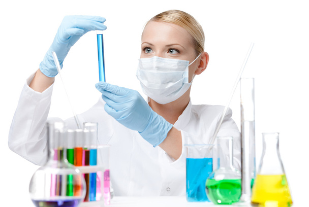 Female chemist in respirator holds a vial - Photo, image