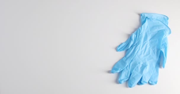 Female hands putting medical gloves, masks and sanitizer on the table - Felvétel, videó