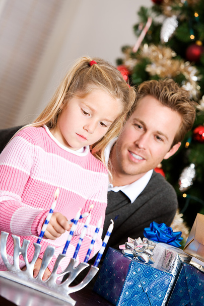 Holidays: Dad Watches Girl Light Candles - Photo, image
